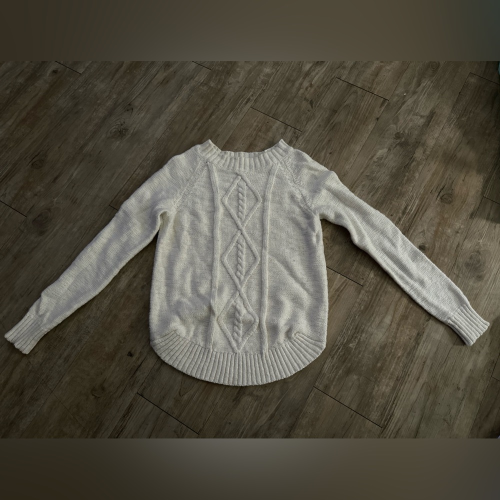 Woman’s white knitted sweater